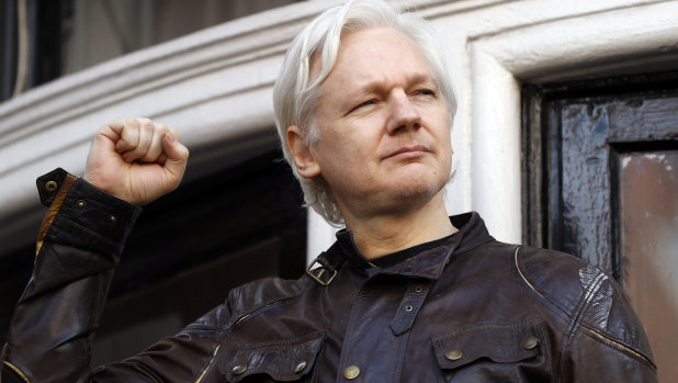 WikiLeaks founder Julian Assange greets supporters outside the Ecuadorian embassy in London in May.