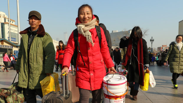Hou Ping, 48, brought a plastic bucket with her to Beijing station as she failed to get a seat ticket.