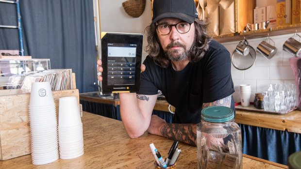 Cafe owner Chris Holland was forced to give away coffees after Commonwealth Bank's terminals went kaput.
