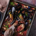One-tray mussels with smoky tomato and butter beans.