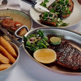 Black angus steak with herb butter, and bone marrow on toast (rear).