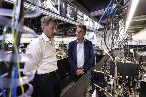 Professor Michael Biercuk and NSW Transport Minister inspect a quantum computer at the University of Sydney.