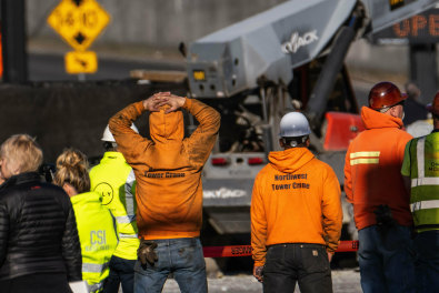 Police investigate the scene of a construction crane collapse in Seattle that left four dead.