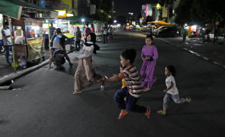 Children play in the middle of Sabang Street, a street food centre popular among locals and tourists in Jakarta.