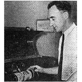 At 6.59pm Mr. Bill Ferguson, O.T.C. photogram officer, flicks the switch to begin sending through the picture file on an open line to London. 
