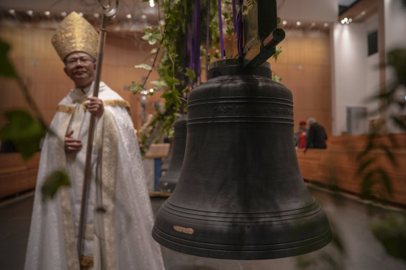 The Bishop of Parramatta Vincent Long with the bells after they were anointed and blessed with oil and incense.