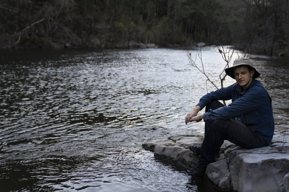 Harry Burkitt, who has led the campaign against the Warragamba Dam wall raising, sits by the Kowmung River.