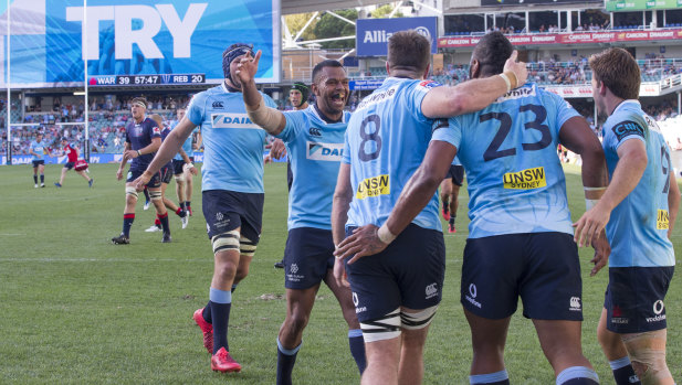 Right formula: Kurtley Beale rushes in to congratulate Taqele Naiyaravoro on his try as the Waratahs finish strongly.