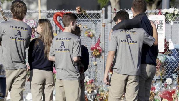 Students return to Marjory Stoneman Douglas High School after the Valentine's Day shooting.