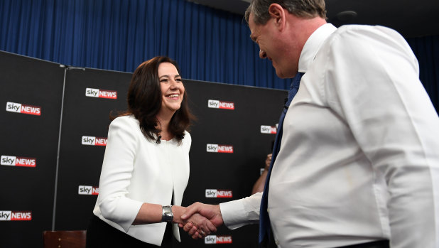 Queensland Premier Annastacia Palaszczuk shakes hands with Leader of the Opposition Tim Nicholls.