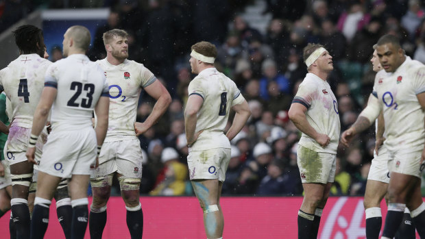 Dispirited: England's players react after Ireland score their third try.