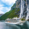 Viking Sky in front of the Seven Sisters Waterfall in Geiranger Fjord, Norway.