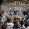 An electoral officer holds up votes as they are counted at a polling station in Lagos, Nigeria on Saturday.