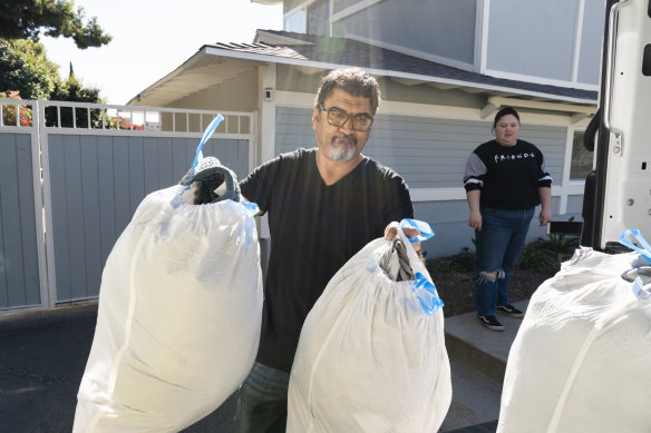 Sedat Deniz loads donations into his company’s truck in Los Angeles.