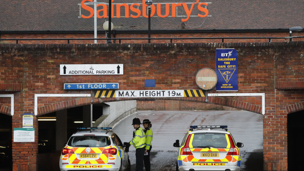 Police close the entrance to the car park of a supermarket after finding an abandoned car near to where former Russian double agent Sergei Skripal and his daughter were found critically ill.