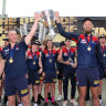 Wiiners: Coach Simon Goodwin and captain Max Gawn hold the premiership Cup aloft the day after their premiership win.