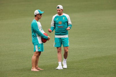 Justin Langer chats to captain Tim Paine at Australian training.