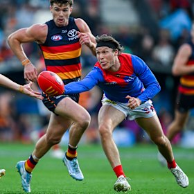Ed Langdon looks to gather possession ahead of Ben Keays.