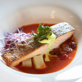 The Astor Gril's crisp skinned Tasmanian salmon  with potato confit, roasted capsicum & golden apple broth.