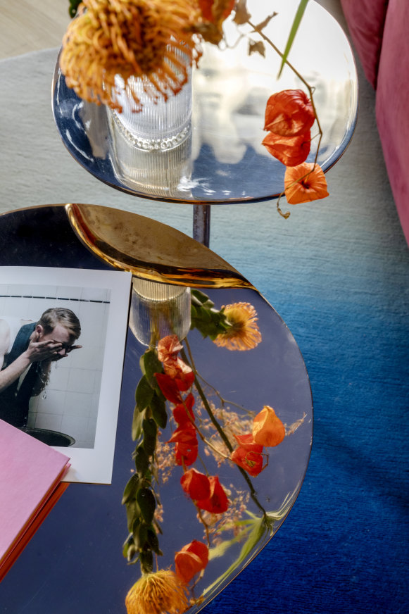 “Mushroom” coffee tables by Henge are paired with an “Iris” rug by Illulian.