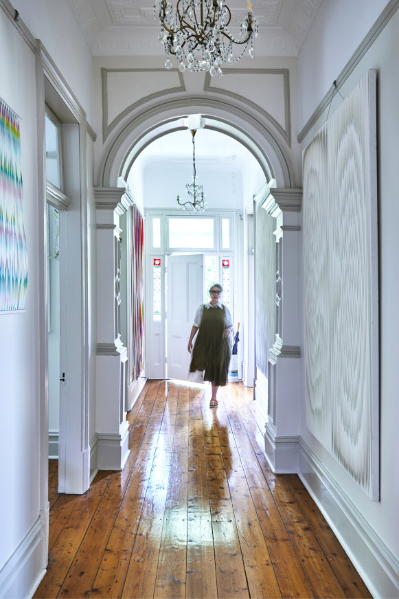 The hallway is painted in antique white and features large artworks by Packer. The vintage chandeliers were bought from an antique store in Marrickville. 