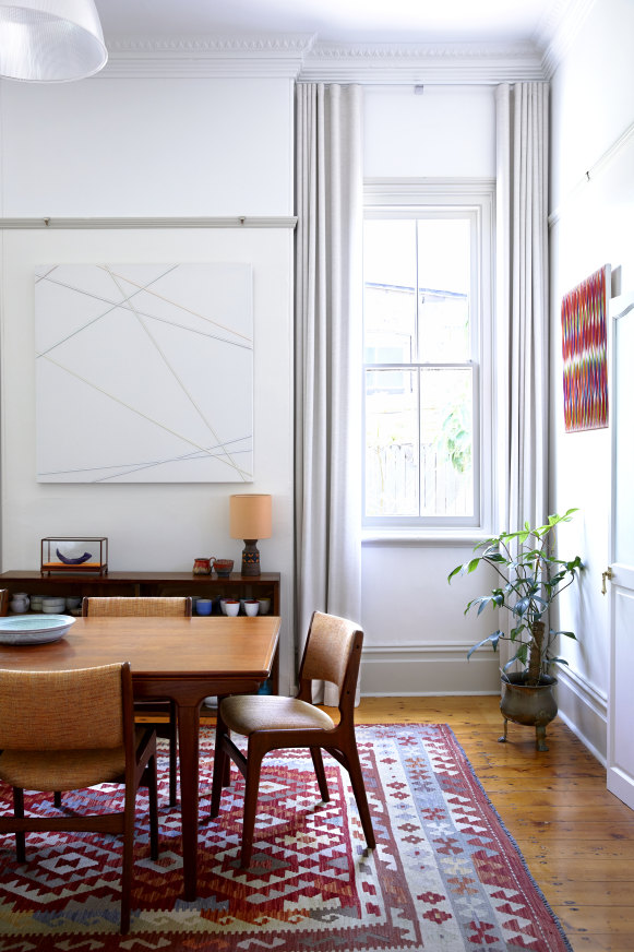 This formal dining room is used mostly for entertaining because the table pulls out to seat 10. Dining suite from Vampt. Kilim - Nazar Rugs Artworks by Chris Packer. 