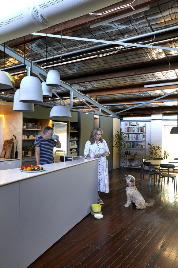 Kirton, Simpson and Molly the wheaten terrier in the open-plan kitchen.“We’ve got all the Mud pendant lights above the bench, which was a fun installation,” says Simpson.