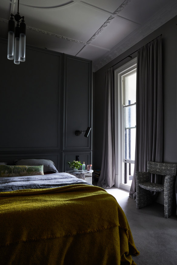 In the main bedroom, a custom-built panelled wall acts as both bedhead and disguise for the wardrobe behind. The wall colour is Dulux “Champignon” in half strength.