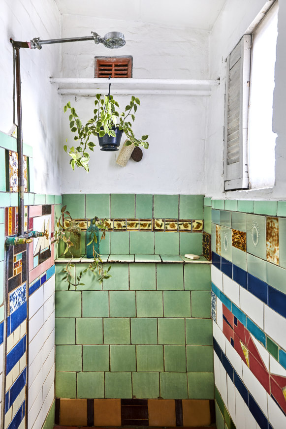 One of the inner-city warehouse’s previous tenants tiled the bathroom using an eclectic and characterful selection of vintage tiles.