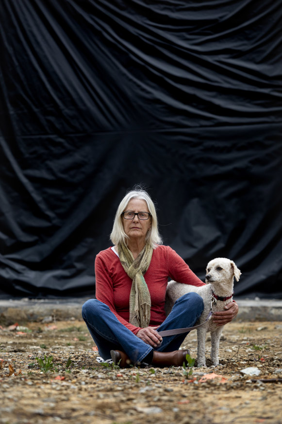 Jann Gilbert at her destroyed home almost a year on.  
