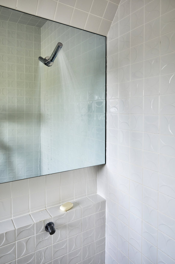 The bathroom tiles were specifically chosen and oriented to reflect light.  