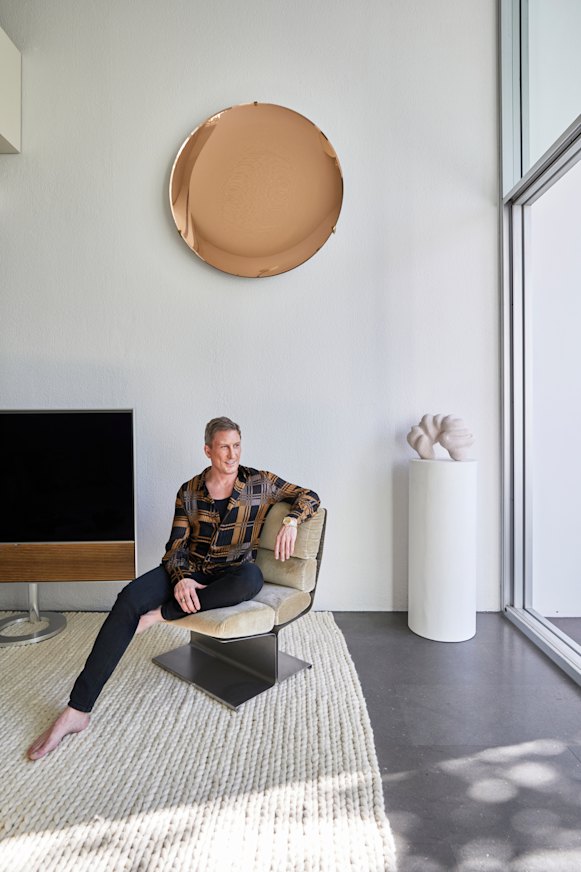 David Hicks seated on a 1970s Uginox lounge chair. The sculpture is by Narelle White and the copper glass disc is from eModerno.  