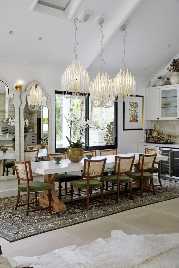 The dining area features a custom table from Camargue, in Mosman, which seats 
eight on 1950s Italian oak chairs. Overhead are Arteriors “Tilda” chandeliers.