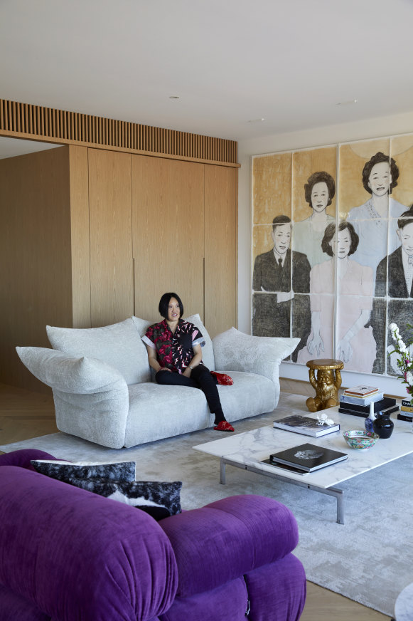 Elizabeth Pakchung on an Edra “Standard” sofa. Also featured are a B&B Italia purple “Camaleonda” sofa and a Kartell “Gnome” stool by Philippe Starck. The artwork is Family Portrait by Matt Chun.