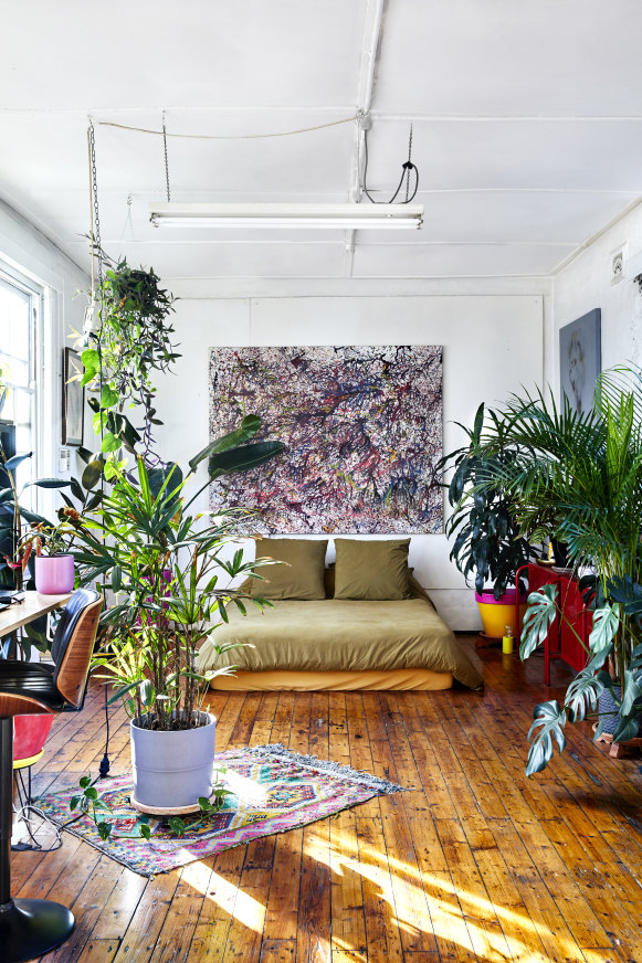 The “jungle oasis” consists of plants collected by David and his brother Andrew, who lived here before him. The painting over the bed is the first Andrew ever did.