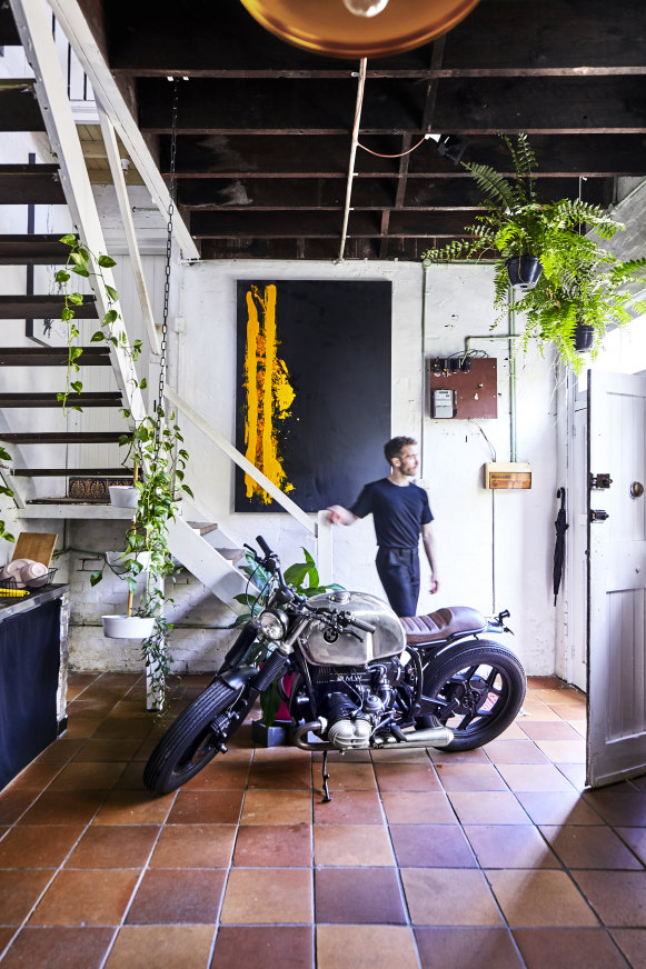 David Nakhla at the street entrance. A 1987 BMW motorcycle, his brother Andrew’s passion project, is an unorthodox centrepiece.