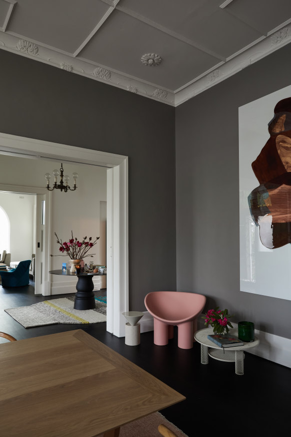 In a corner of the formal dining room, a Faye Toogood “Roly-Poly” chair sits beside a large work in oil on plexiglass by Melbourne artist Camille Hannah