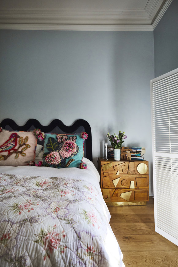 In the main bedroom, a vintage chest of drawers from eModerno serves as a bedside table. The cushions are from Nyary Store in Albert Park.