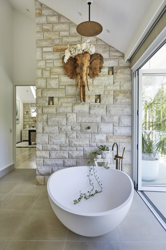 A carved Bisque Traders elephant head adorns the wall in the master bedroom’s ensuite. The bath is by Mastella and the brass tapware from Candana Designs.