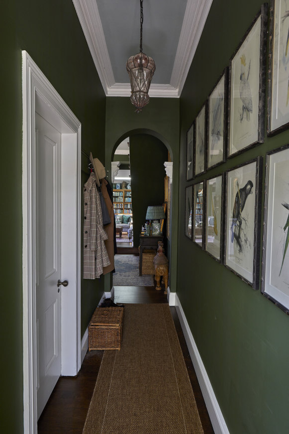 The hallway features prints of parrots by Edward Lear, better known for his nonsense poetry. The Turkish glass pendant lamp is a vintage piece from Isla Design.