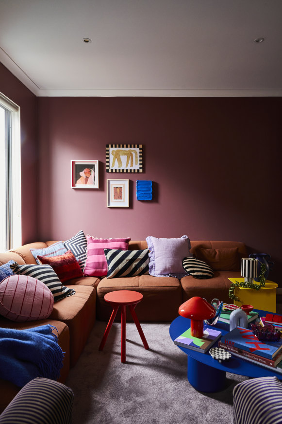 “We have regular movie nights and reconfigure the Eva sofa into a big bed so we can stretch out,” says Banfield. The wall colour is “Lampoon” by Dulux and the artwork at left  is by Stacey Rees.