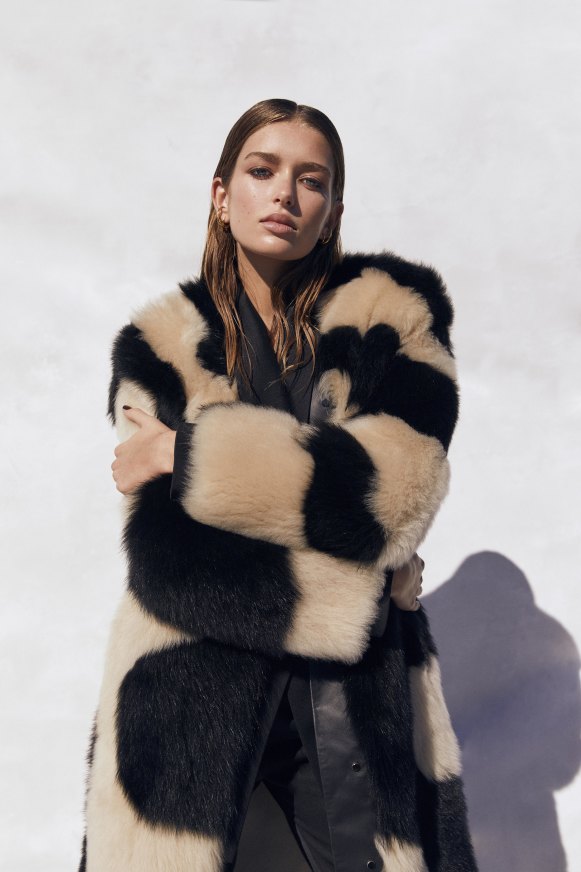 Zimmermann “In Illustration” faux fur coat, $3500, silk jacket, $1500, and pants, $625. Charlotte Chesnais “Triplet” earrings, $845 each.