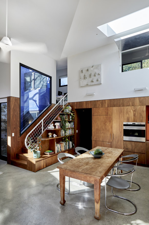 Shoes off on entry; the polished concrete floors feature underfloor heating. A double-height ceiling with skylight and large windows ensure natural light floods the home.