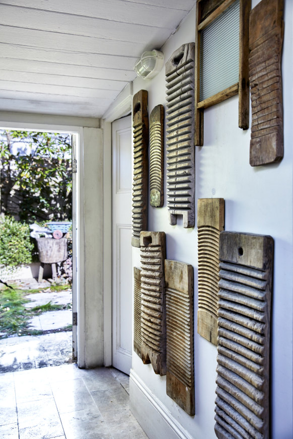 A storage area next to the bathroom leads out to a leafy courtyard, with French antique washboards on the wall. “I picked these up in Paris,” says Normyle.