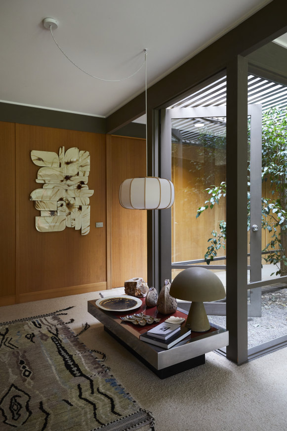 Timber panelling features on the walls and Haag has layered the home with her signature mix of design 
influences. The wall art is by Eline Baas and the pendant light is from Japanese maker Time & Style.