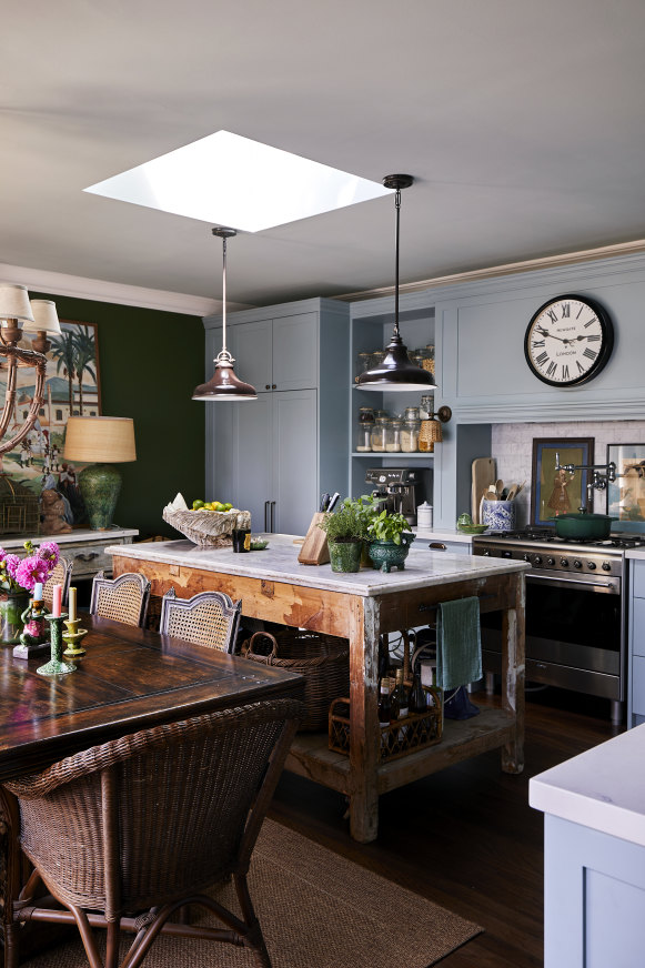 The kitchen evokes an English country house. The pot-filler tap over the stove is one of Baker’s favourite gadgets and the bench is a vintage French baker’s table. 