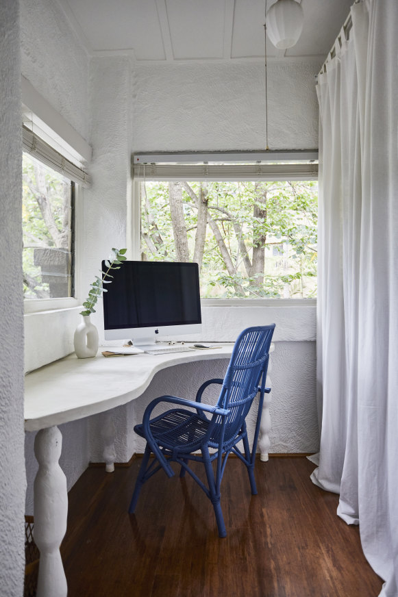 “I couldn’t find an organically shaped desk for this space so my mother offered to custom-make this one,” says Bailey.  “I’ve had the cane chair for years but recently painted it blue.”