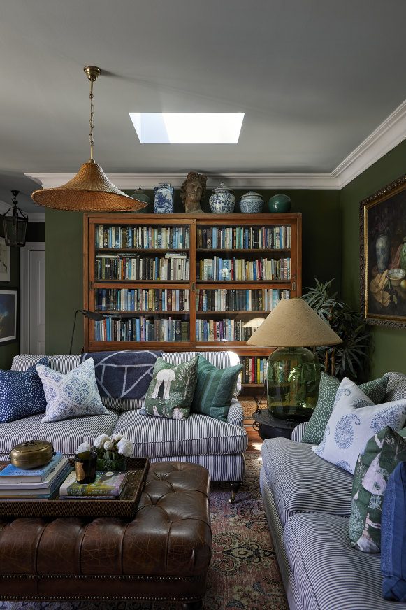 A well-placed skylight floods the living room with light. The antique Indonesian bookcase is from Orient House, and Isla Design cushions add further comfort to a feather-filled couch.