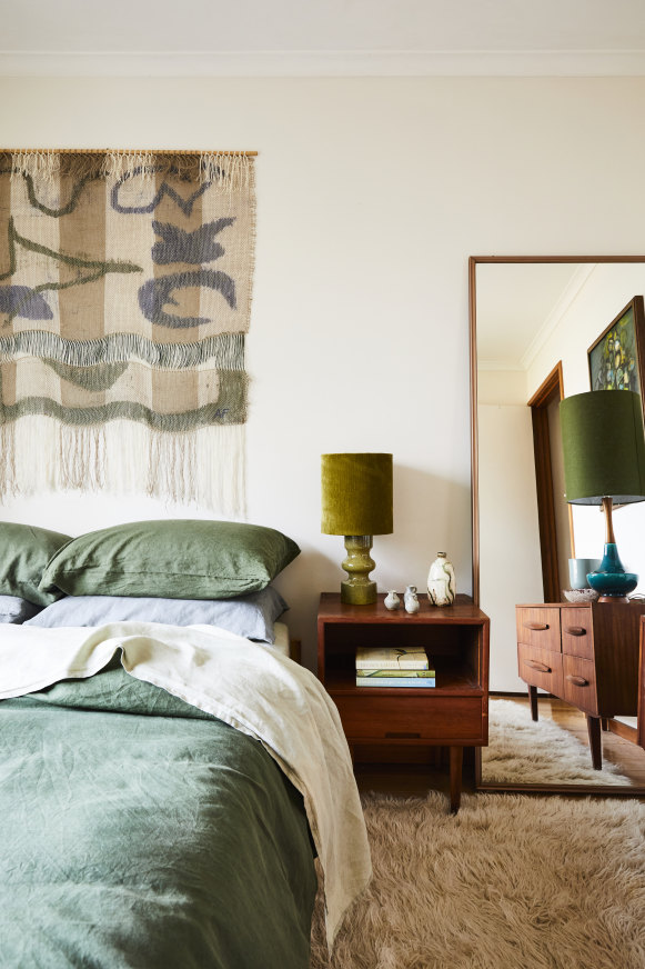 A woven artwork by Melbourne artist Anna Fiedler hangs in the guest bedroom. The bed linen is from Bed Threads and the lamps from Retro Print Revival.