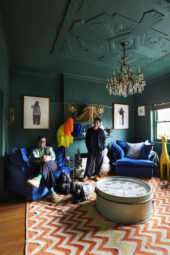 “Changing the walls from stark white to deep green created a moodier feeling in the space,” says Ben Elliott (left). The velvet chairs are by Molmic Furniture.